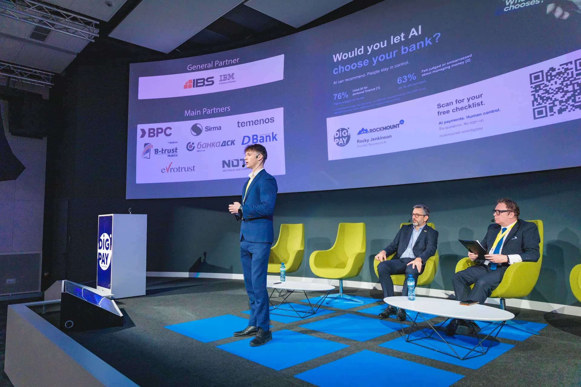 Side view of Rocky Jenkinson speaking beneath his Would you let AI choose your bank presentation at DIGI PAY